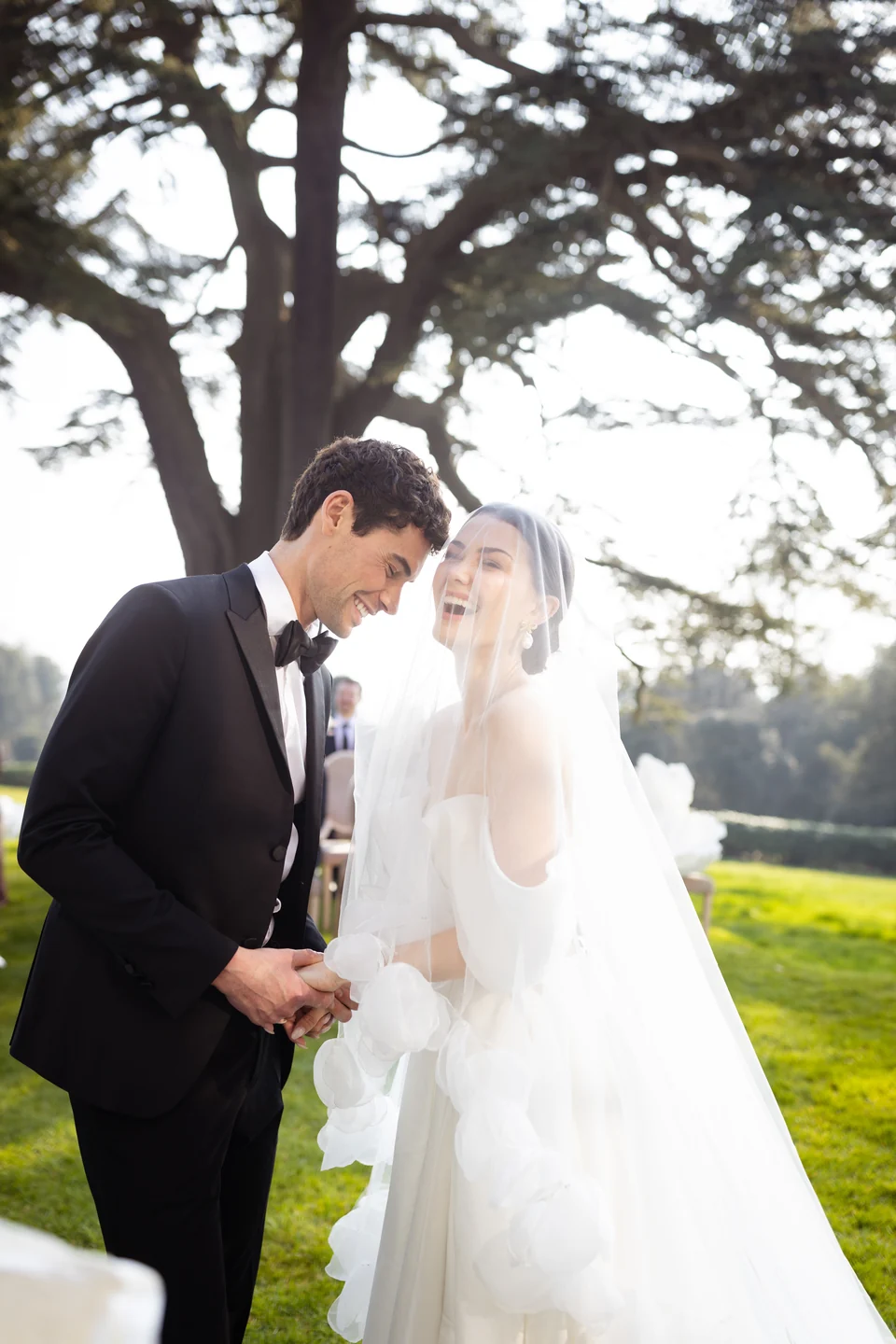 Wedding couple embracing in a sunlit garden