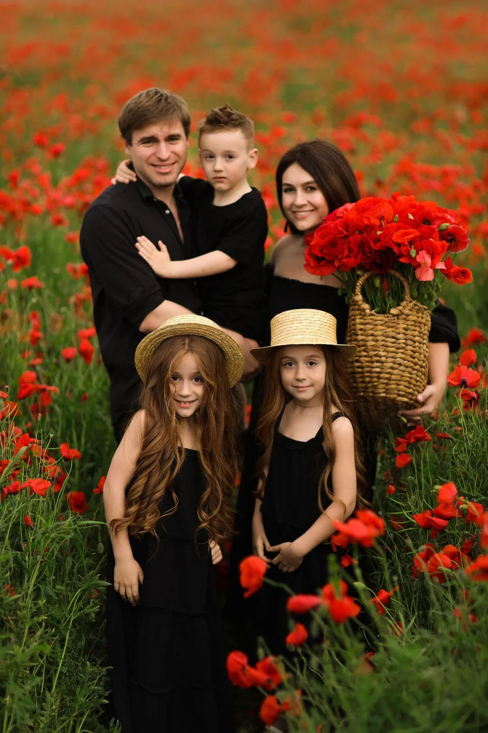 Family together in a bright poppy field