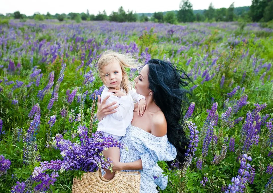 A tender moment captured in a field of purple lupines on a summer day.