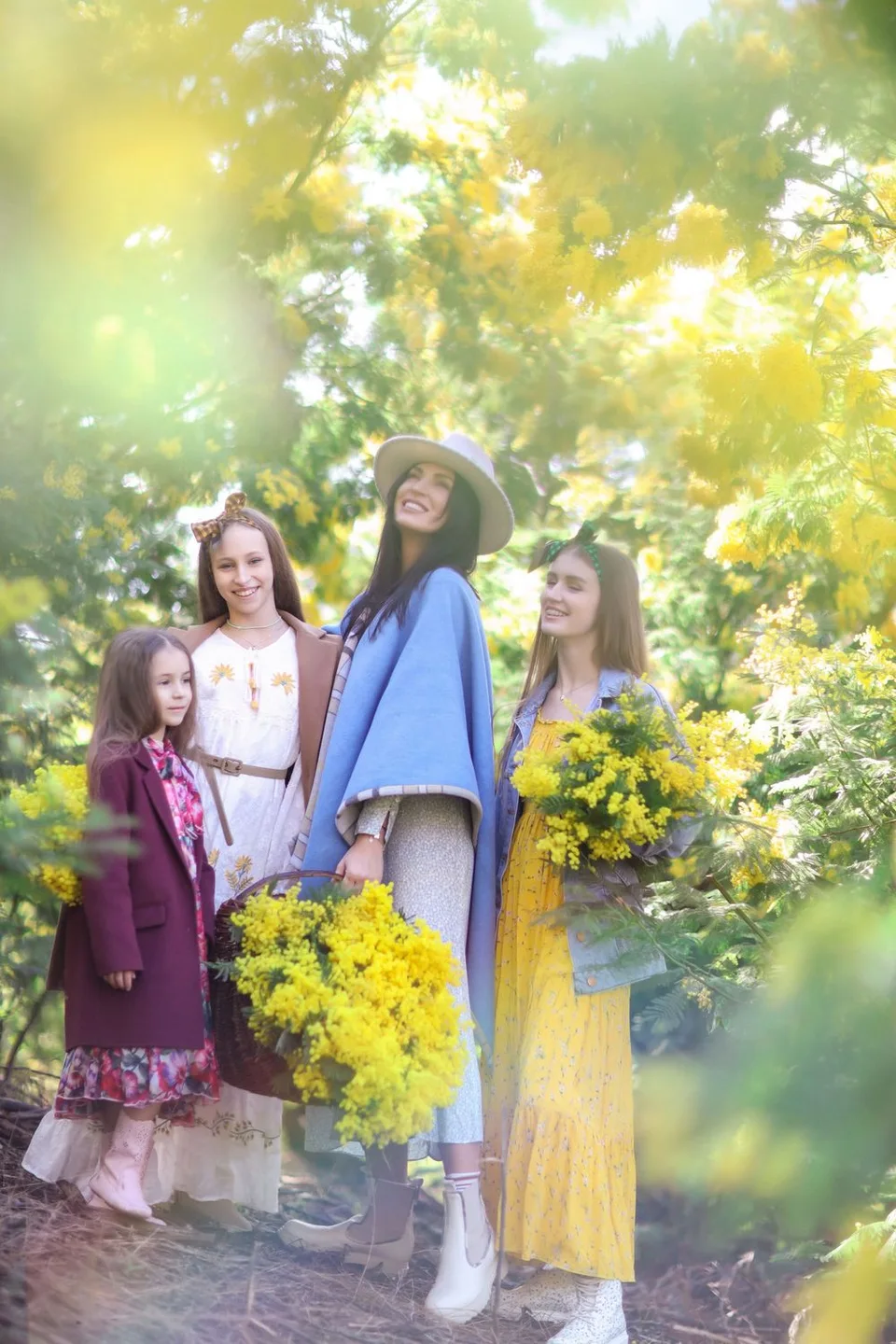 Friends gathered among blooming yellow flowers in springtime garden setting.