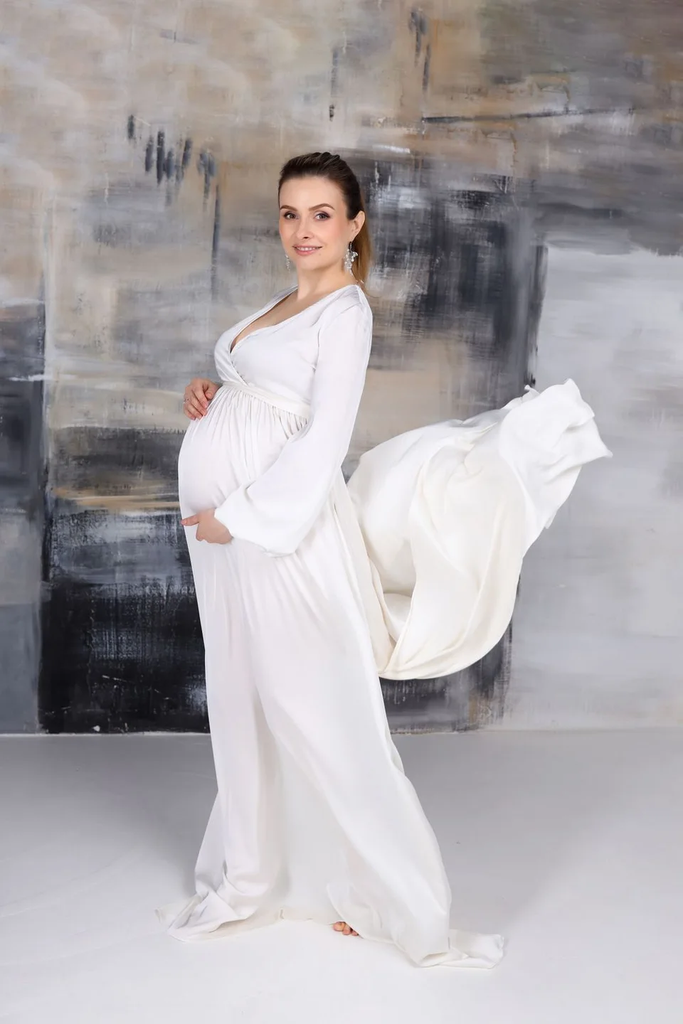 Maternity portrait in a flowing white gown