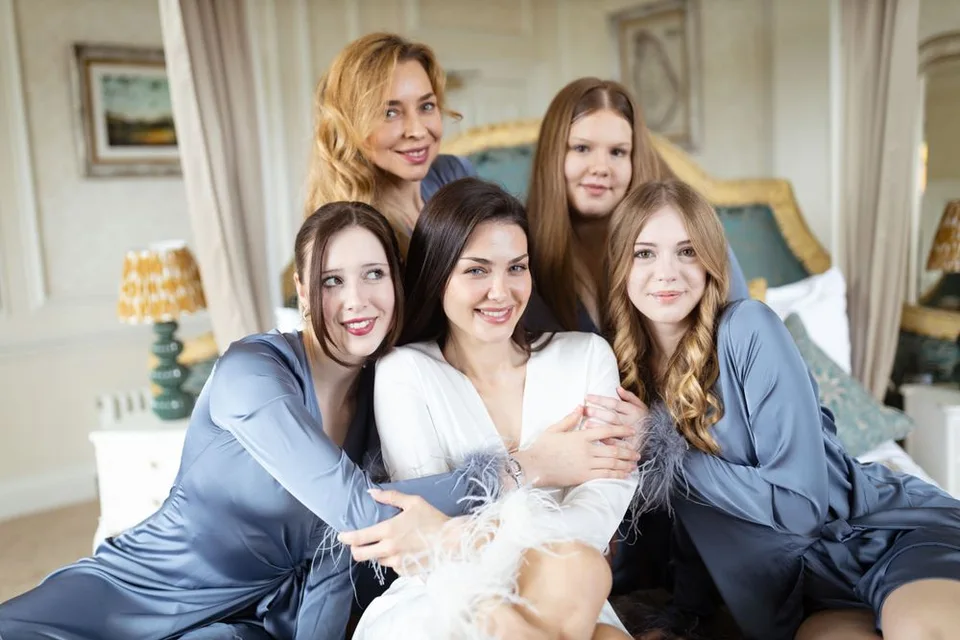 Bridal party celebrating with cheers and laughter during the pre-wedding festivities in West Sussex