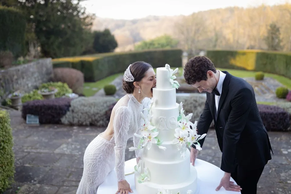 Couple eating wedding cake on their wedding day.