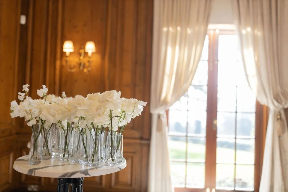 Beautifully arranged floral centrepieces at the wedding reception in East Sussex, enhancing the romantic ambiance.
