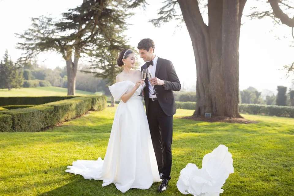 Couple enjoying a quiet moment on a scenic overlook during their wedding day in Kent, surrounded by breathtaking views.