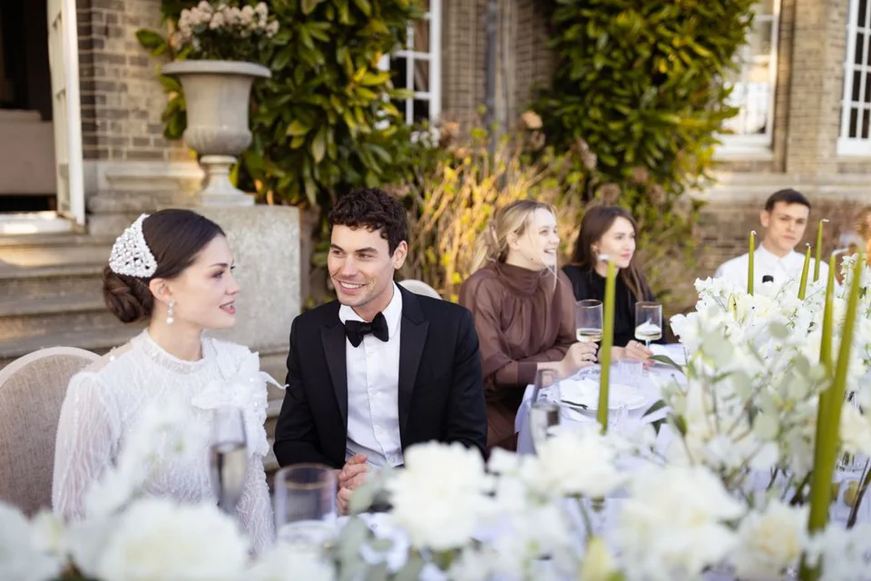Couple surrounded by loved ones during a group photo at their wedding in Kent, creating lasting memories.