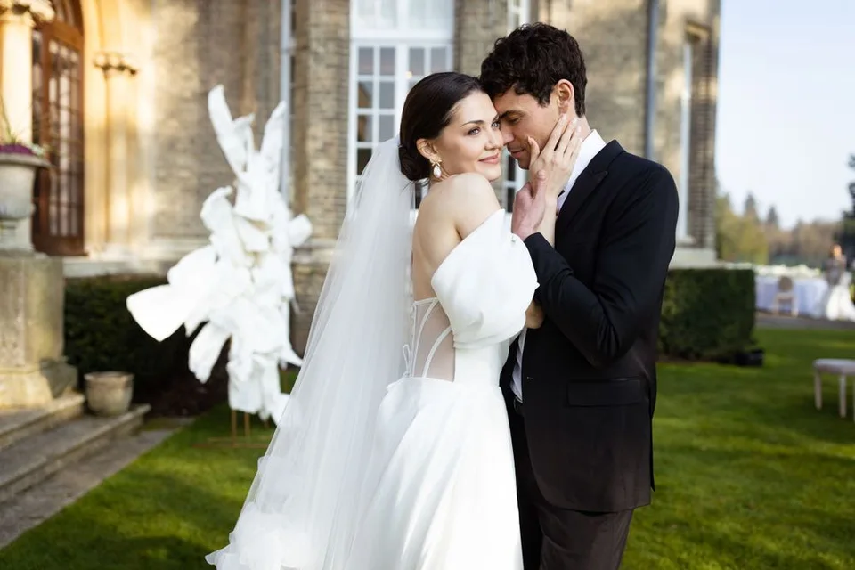 Candid moment of the couple laughing together during their wedding reception in Sussex, capturing their happiness.
