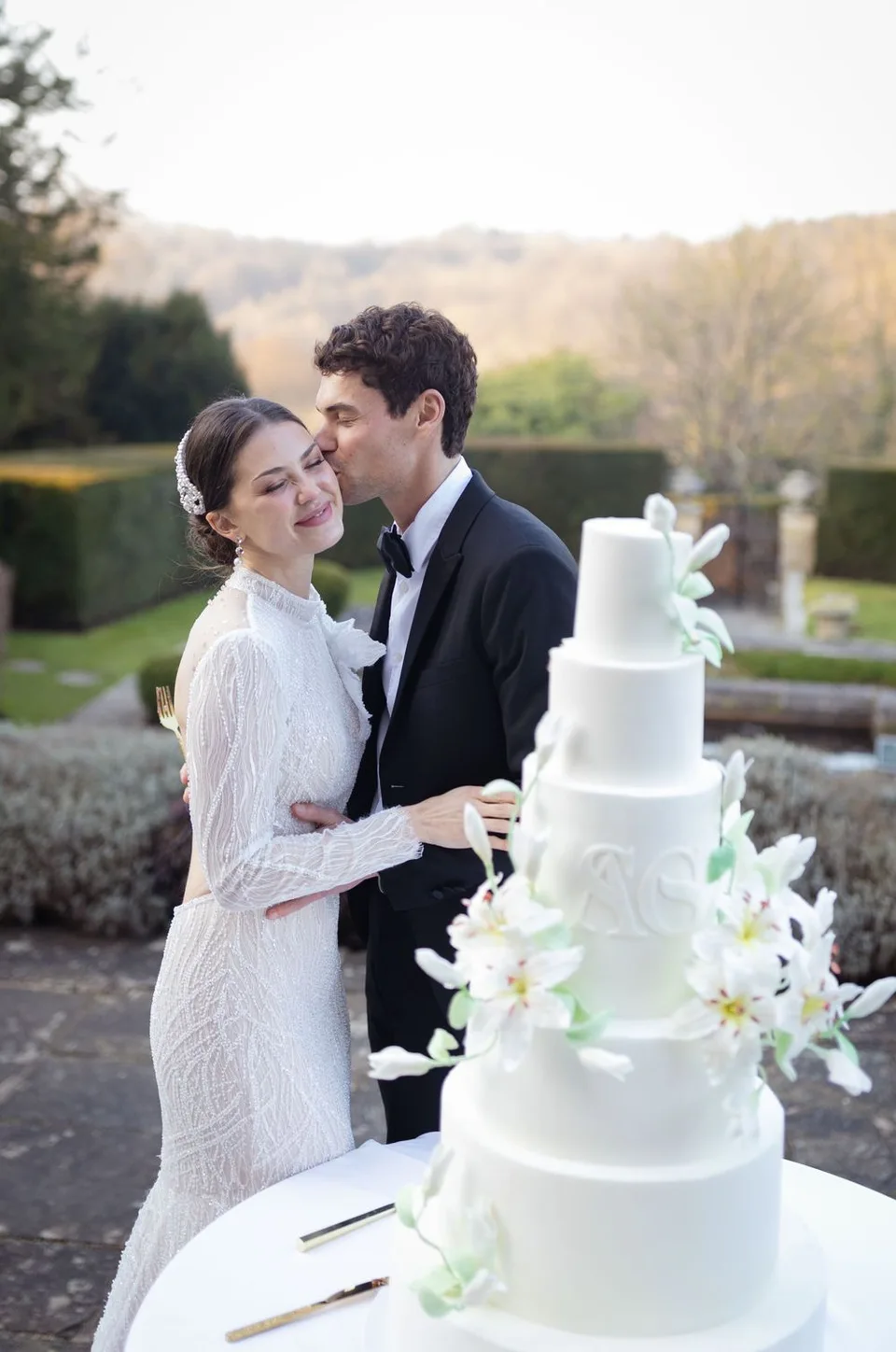 Beautifully decorated cake table at the wedding reception in Kent, showcasing the couple's unique style and theme.