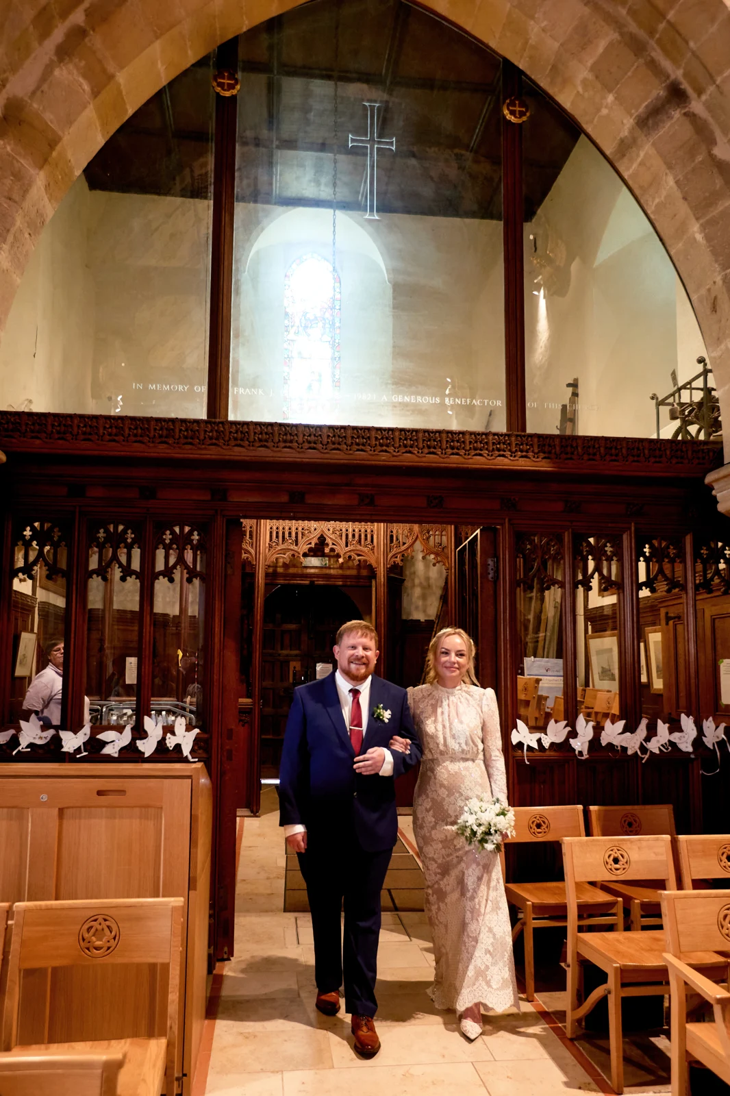 Kate and Rob arm in arm inside Holy Trinity Church, Cuckfield.