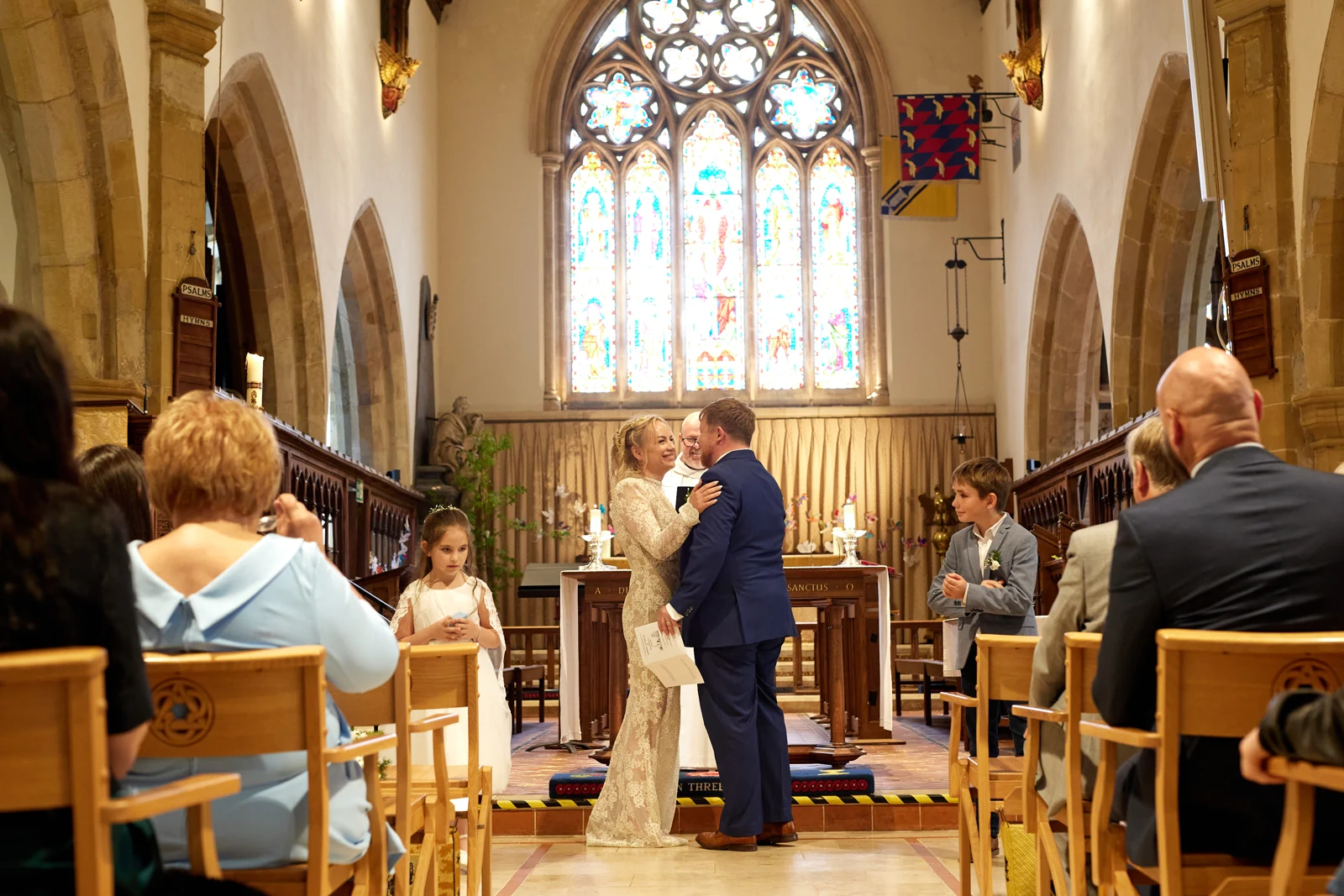 Kate and Rob together in front of the stained-glass window during their Cuckfield church service.