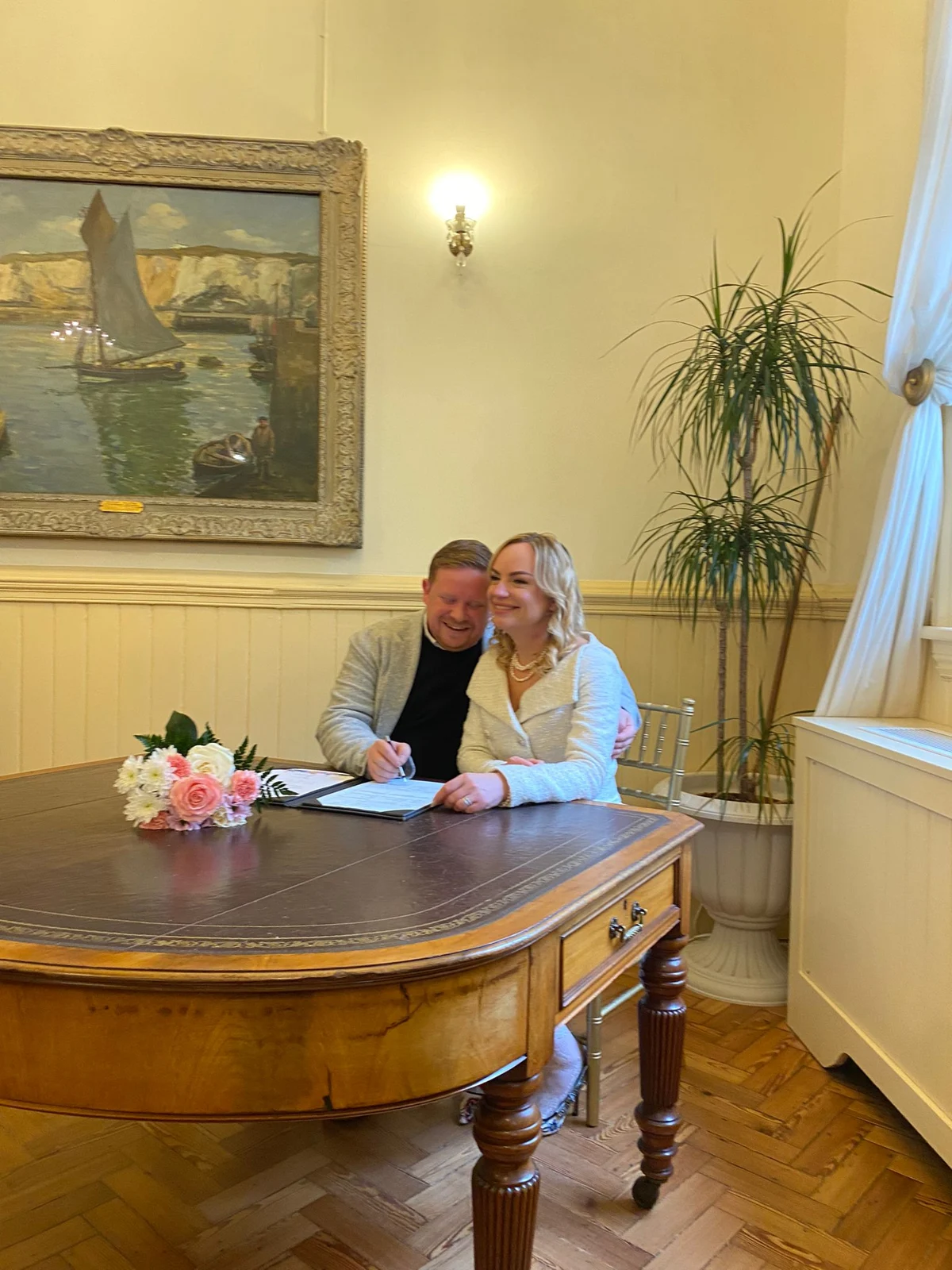 Kate and her husband together at the signing table during their Brighton Town Hall wedding.