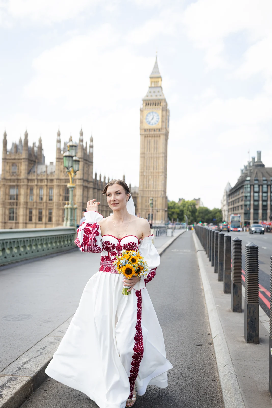Lena in her embroidered wedding dress with Big Ben in the background.