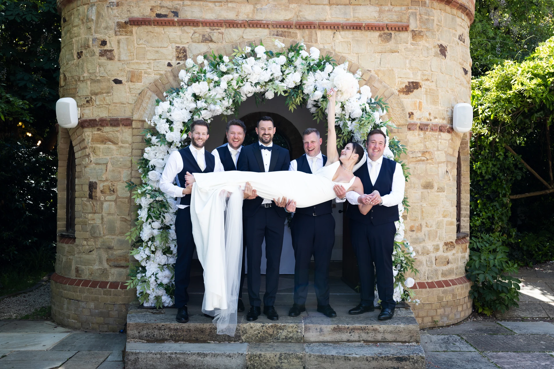 A playful wedding-party photograph at The Ravenswood