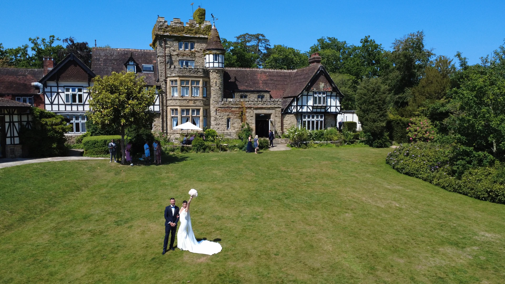 A drone view of Jen and Stu on the lawn at The Ravenswood